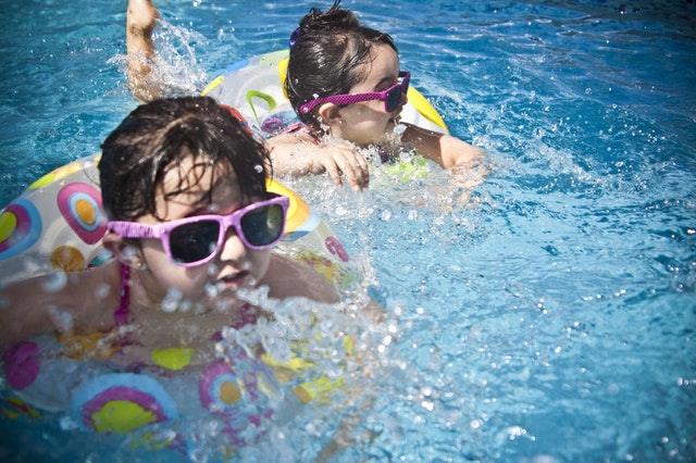 Kids wearing sunglasses and playing in a pool - El Paso TX