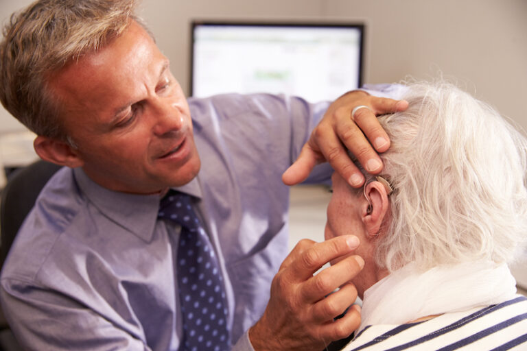 Man being fitted with a hearing aid in El Paso