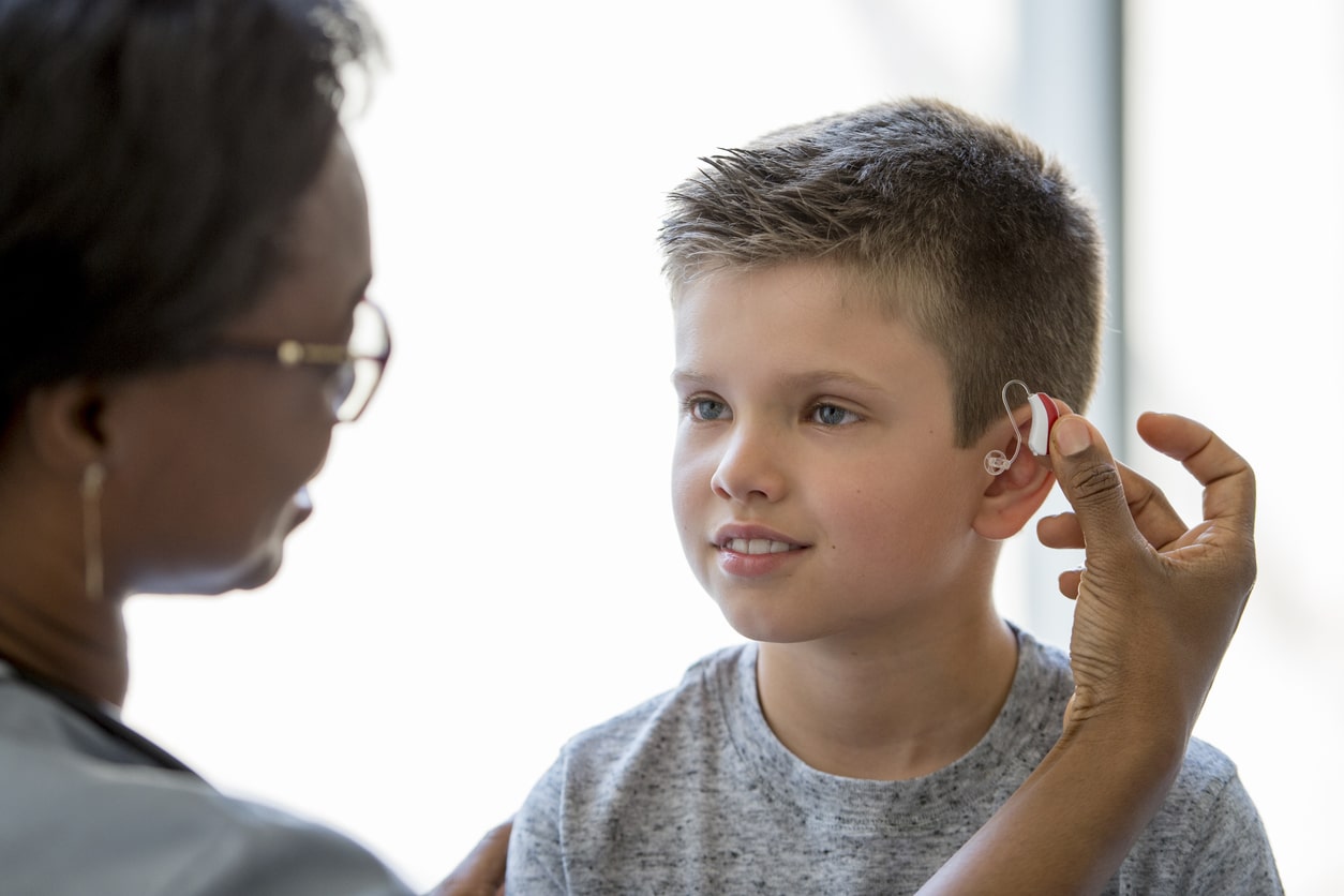 Young boy with hearing aids Young boy with hearing aids