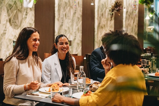 Four friends having dinner together.